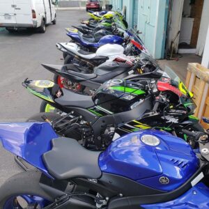 Motorcycles being prepared for transport or storage at Track Bike Rentals