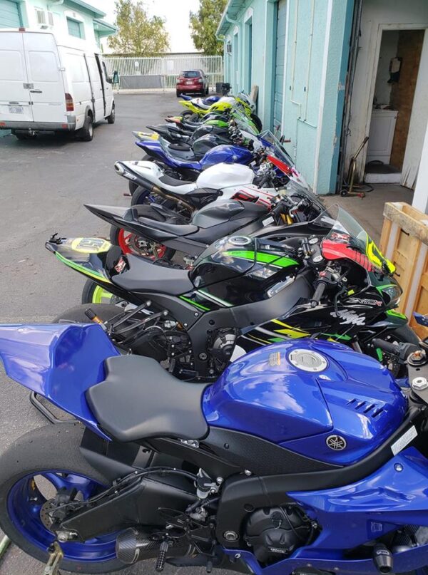 Motorcycles being prepared for transport or storage at Track Bike Rentals